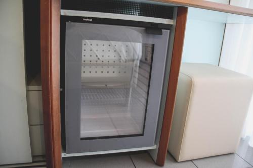 an empty refrigerator with its door open in a kitchen at Hotel Gaby in Rimini