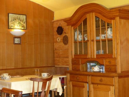 a kitchen with a table and a china cabinet at Landhaus Gritschacher in Sankt Peter in Holz