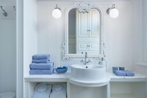 a white bathroom with a sink and a mirror at Vondelpark House B&B in Amsterdam