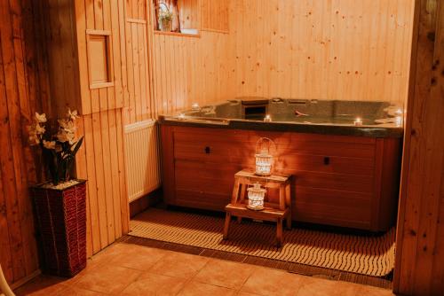 a bathroom with a tub and a table in a room at Penzion Javorina in Čičmany