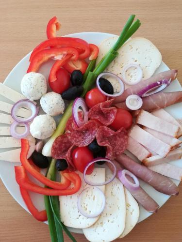 a plate of food with vegetables on a table at Pensiunea Daria in Fundata