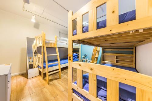 a bedroom with bunk beds in a hostel at Sinchon Sisters Hostel in Seoul