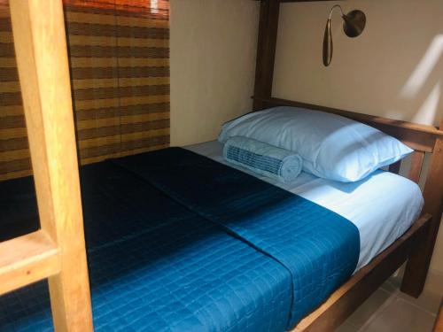 a bedroom with a bunk bed with a blue pillow at Hostel Ilha do Amor in Fernando de Noronha