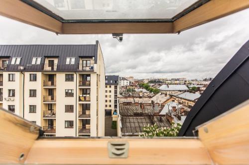 a view of the city from the balcony of a building at BonApart Delux in Lviv