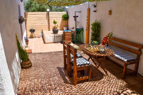 a patio with a table and chairs on a tiled floor at Afrodites Residence Triopetra in Triopetra
