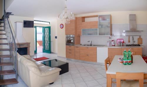 a living room and kitchen with a couch and a table at B&B CASA VACANZA Cioffi in Vico Equense