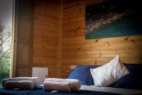 a room with a blue couch and a wooden wall at Campamento Turístico Brandoñas in Brandoñas