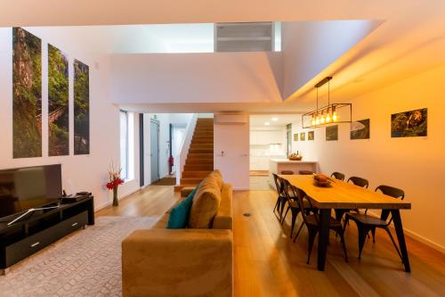 a living room with a table and a couch at H. S. Caloura in Lagoa