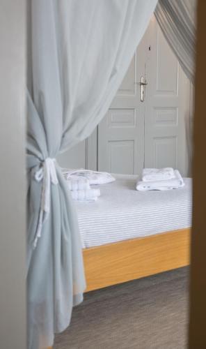 a bedroom with a bed with a curtain at Douskos Guesthouse in Hydra