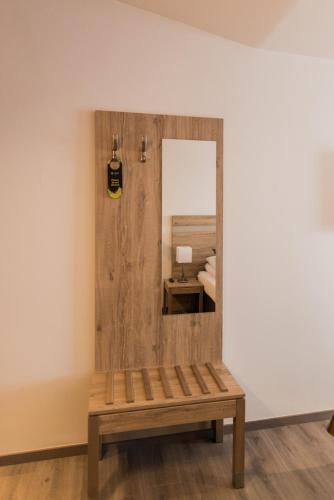 a mirror and a bench in a room at Hotel Duus by Keflavik Airport in Keflavík