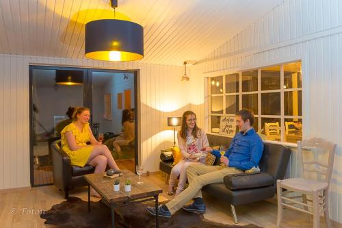 a group of people sitting in a living room at Rosy Garden in Lichtervelde