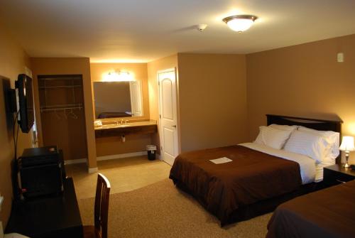 um quarto de hotel com uma cama e um lavatório em Abbot Trailside Lodging em Abbot Village