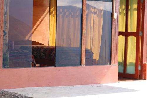 a reflection of a bed in a window at Llactapata Lodge overlooking Machu Picchu - camping - restaurant in Salcantay