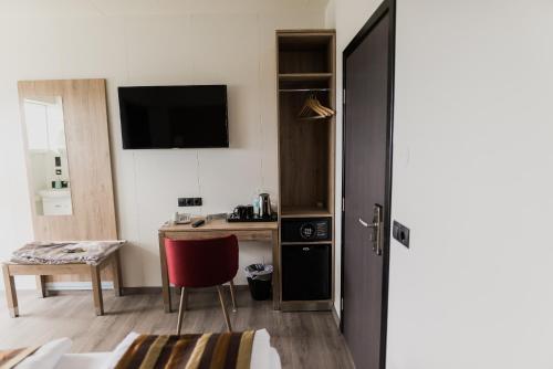 a room with a desk and a table with a chair at Hotel Duus by Keflavik Airport in Keflavík