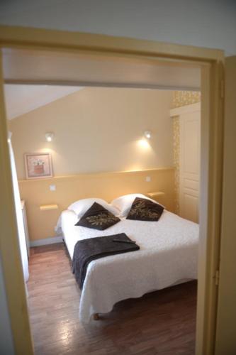 a bedroom with a white bed with two pillows at Ondoria in Itxassou