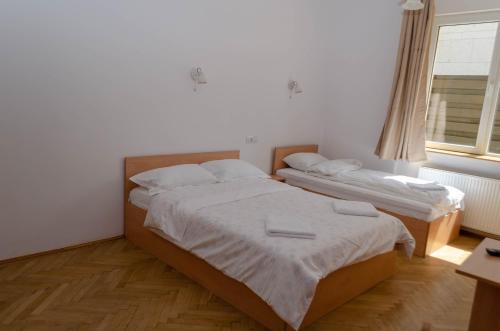 Postel nebo postele na pokoji v ubytování Casa Rezidentiala Pasteur