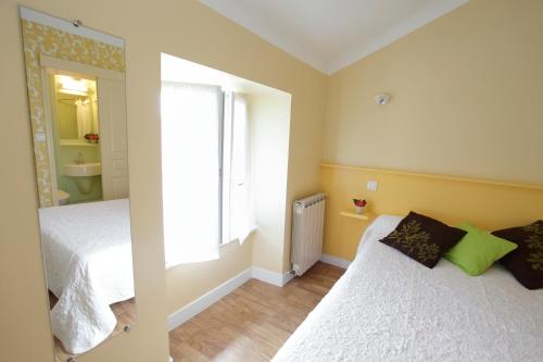 a small bedroom with a bed and a window at Ondoria in Itxassou
