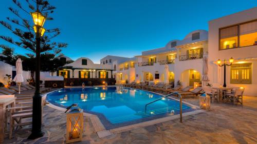 a pool in front of a hotel at night at Hotel Mathios in Akrotiri