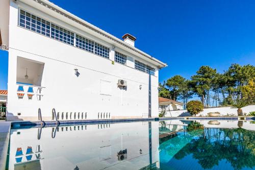 a house with a swimming pool in front of it at AYAMI Villa in Setúbal