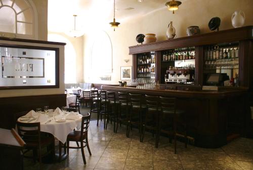 a restaurant with tables and chairs and a bar at The Andrews Hotel in San Francisco