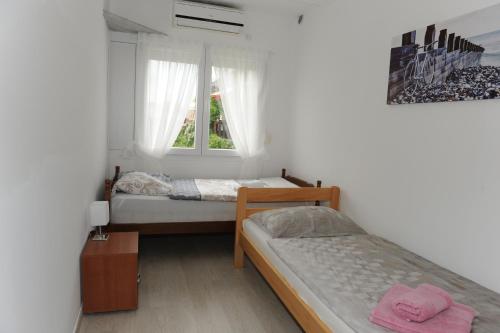 Postel nebo postele na pokoji v ubytování Apartmani Ivišić