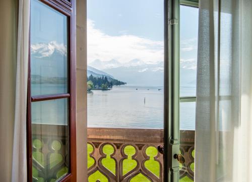 a view of a lake from a window at Schloss Schadau - Swiss Historic Hotel in Thun