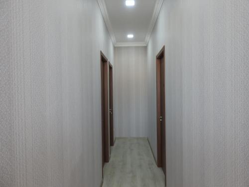 an empty corridor with two doors and a corridorngthngthngthngthngth at White Hotel Guesthouse in Zugdidi