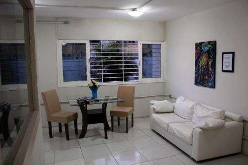 a living room with a couch and a table at Casa da Esquina Pousada in Recife