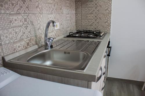 a kitchen with a sink and a stove at i giardini di edicart in Bari
