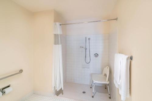 a bathroom with a shower with a chair in it at Comfort Inn & Suites Brentwood - Nashville in Brentwood