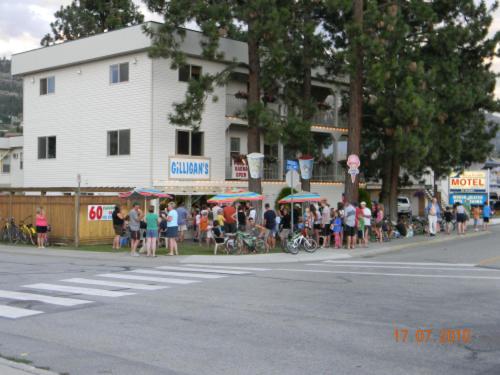 a crowd of people standing on the side of a street at Beachside Motel in Penticton