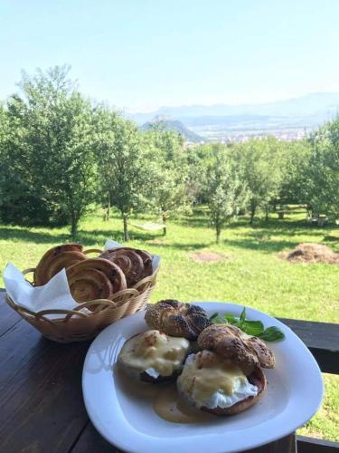 a plate of pastries on a table with a basket of bread at Hanu lu Mos Opinca in Deva