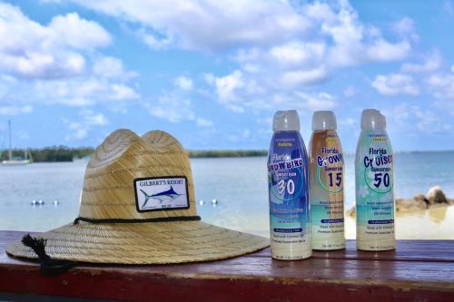 a straw hat sitting on a table with three bottles of water at Gilbert's Resort in Key Largo