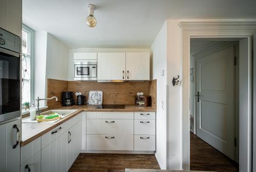 a kitchen with a sink, stove, refrigerator and cabinets at Ferienwohnungen Finkenherd 5 in Quedlinburg