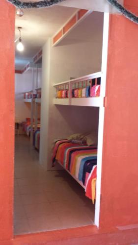 a room with two bunk beds and a red wall at Mi casita en puebla in Puebla