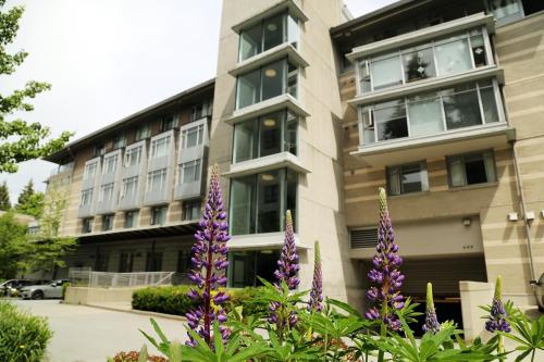 a building with purple flowers in front of it at Carey Centre in Vancouver