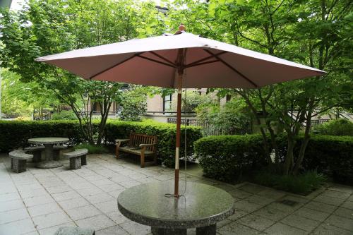a table with an umbrella on a patio at Carey Centre on UBC campus in Vancouver