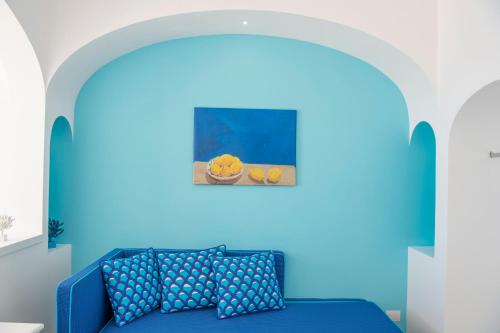a blue and white striped bed in a blue room at Tramonto d'Oro in Praiano