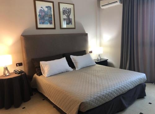 a bedroom with a bed with two white pillows at Domizia Palace Hotel in Baia Domizia