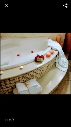 a bath tub filled with towels and a red at Lasa Valley Villa in Lasa