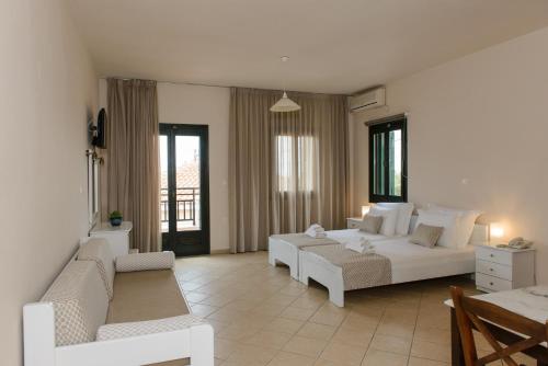 a living room with a bed and a couch at So Nice Hotel in Marathokampos