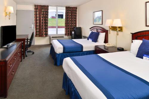 Postel nebo postele na pokoji v ubytování Castle Inn & Suites Anadarko