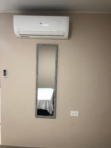 a mirror on a wall in a room at Tropical Dreams in San Andrés