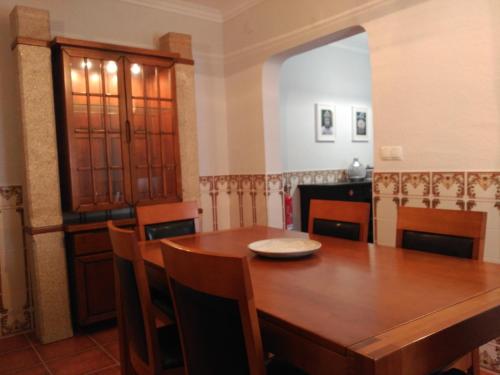 a dining room with a wooden table and chairs at Casa Viela in Viseu