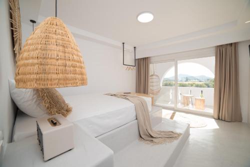 a living room with a pendant light and a couch at Iphimedeia Luxury Hotel & Suites in Naxos Chora