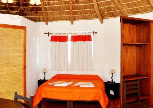 a bedroom with a bed with two towels on it at Termas Sol Y Luna con AGUA TERMAL in Termas del Daymán