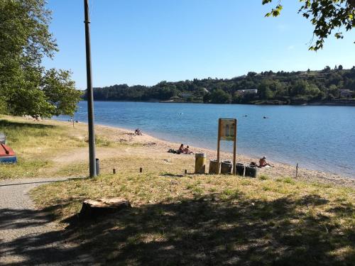a beach with people on the sand and water at Green Villas Douro in Gondomar