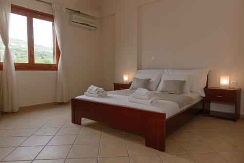 a bedroom with a bed with towels on it at So Nice Hotel in Marathokampos