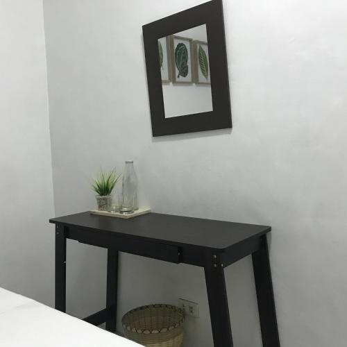 a black table with a mirror on a wall at Ignacio’s Place in Bacolod