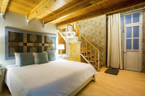 Ένα ή περισσότερα κρεβάτια σε δωμάτιο στο Xoxula by Inmense
